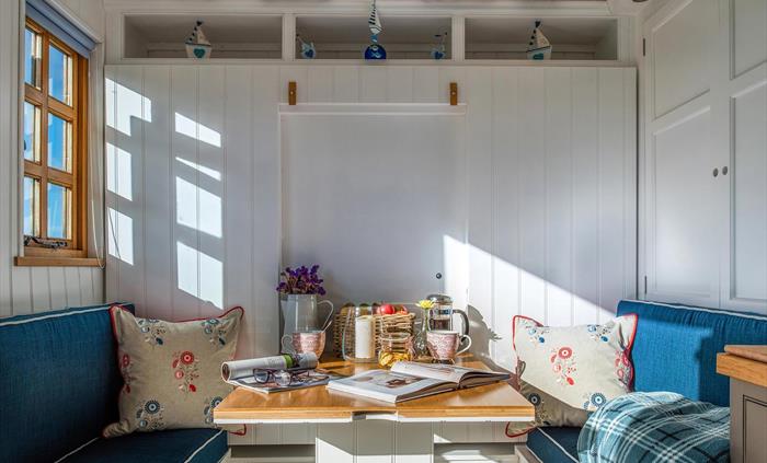 This area folds up and converts to a full size double bed.  On the right is a cleverly designed wardrobe. And there is lots of under-seat storage.